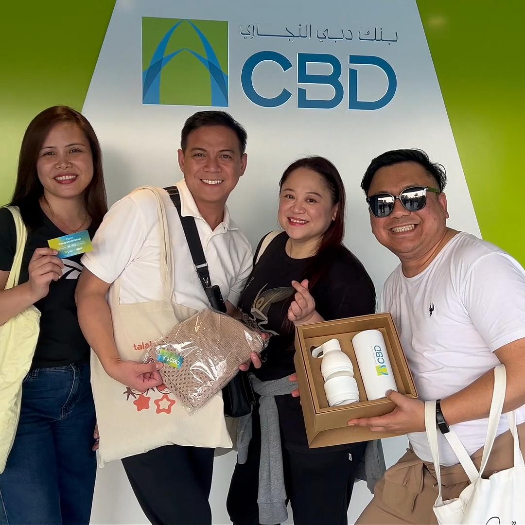 People playing a multi-level interactive financial literacy game at a brand activation event in Dubai, learning how to save and invest money.